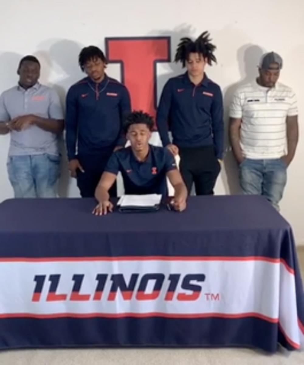 Adam Miller (middle) signs his National Letter-of-Intent with Illinois on April 22, 2020 in front of friends and family via a Instagram Live video. 